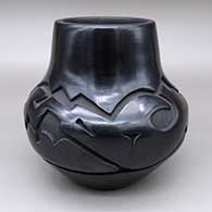 Black jar with a carved avanyu design
 by Phyllis Tafoya of Santa Clara
