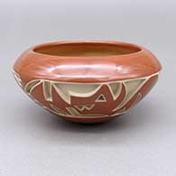 Small red-on-red bowl with a carved and painted avanyu design
 by Marie Suazo of Santa Clara