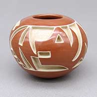 Small red-on-red jar with a carved and painted avanyu design
 by Marie Suazo of Santa Clara