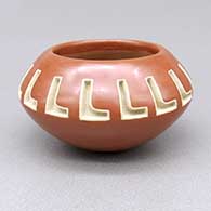 Small red-on-red bowl with a carved and painted geometric design
 by Marie Suazo of Santa Clara