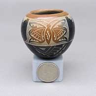 Miniature black jar with a sienna rim and spot and a sgraffito butterfly, feather ring, and geometric design
 by Candelaria Suazo of Santa Clara