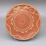 Red plate with a sgraffito avanyu, raincloud, feather ring, and geometric design
 by Adelphia Martinez of San Ildefonso