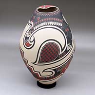 A polychrome jar with a lightly-carved and painted geometric design
 by Tavo Silveira of Mata Ortiz and Casas Grandes