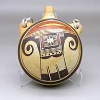 Click for a larger view A polychrome flat-back canteen with handles and decorated on the front with a bird element and geometric design
by Fannie Nampeyo of Hopi