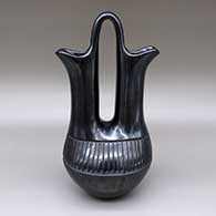 Black wedding vase with a carved feather ring geometric design
 by Toni Roller of Santa Clara