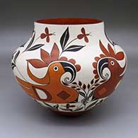 A polychrome jar with a two-panel parrot, branch and flower design
 by Barbara and Joseph Cerno Sr of Acoma