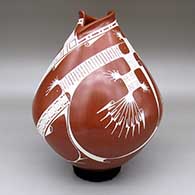 Red and white jar with a geometric cut opening and a painted geometric design
 by Angel Amaya of Mata Ortiz and Casas Grandes