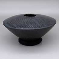 Black-on-black jar with a geometric cut opening, a flat top, and a fine line geometric design
 by Unknown of Mata Ortiz and Casas Grandes