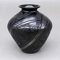 Small black-on-black jar with a flared opening and a painted geometric design
 by Virginia Baca and Salvador Baca of Mata Ortiz and Casas Grandes