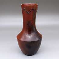 A tall red vase with fire clouds and a rope biyo around the neck
 by Susie Crank of Dineh