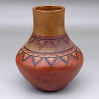 A polychrome jar decorated with bands of sgraffito-and-painted Navajo carpet design above the shoulder
 by Lorraine Williams of Dineh