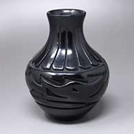 A black water jar carved with an avanyu and ring-of-feathers design
 by Denise Chavarria of Santa Clara