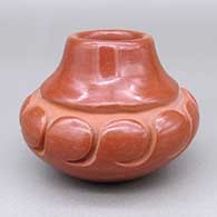 Small red jar with a carved geometric design
 by Anita Suazo of Santa Clara