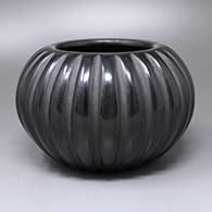 A black melon jar carved with 24 ribs
 by Angela Baca of Santa Clara