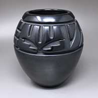 A black jar carved with a two-panel geometric design above the shoulder
 by Toni Roller of Santa Clara