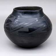 A black-on-black jar with a four-panel geometric design above the shoulder
 by Unknown of San Ildefonso