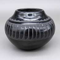Black-on-black jar with a feather ring and geometric design
 by Santana Martinez of San Ildefonso