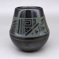 Green-on-black jar with a four-panel geometric design
 by Erik Fender of San Ildefonso