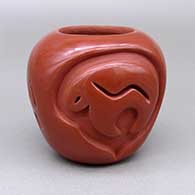 Small red jar with a carved bear-with-heart-line and bear paw design
 by Anita Suazo of Santa Clara