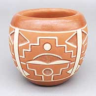 Polychrome bowl with a lightly carved and painted four-panel geometric design
 by Norman de Herrera of Ohkay Owingeh