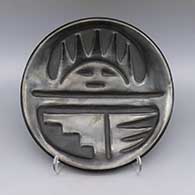 Black plate with carved sun face, kiva step and geometric design
 by Rose Gonzales of San Ildefonso