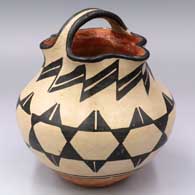 Polychrome jar with a handle and pie crust rim plus bands of geometric design
 by Unknown of Santo Domingo