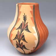 Polychrome jar with a squarish rim, two polished sides carved with melon ribs and two matte sides painted with mature corn plants and geometric design
 by Virginia Ponca Fragua of Jemez