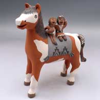 Horse figure with 2 children on its back
 by Leonard Tsosie of Jemez