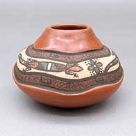 Small polychrome jar with a lightly carved and painted three-panel lizard, flower, and geometric design
 by Betty Jean Fragua of Jemez
