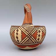 Polychrome friendship basket with twisted handle and geometric design, click or tap to see a larger version
