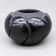 Small black swirl melon jar with nine carved ribs
 by Jason White Eagle Suazo of Santa Clara