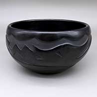 Large black bowl with a carved avanyu design
 by Mary Singer of Santa Clara