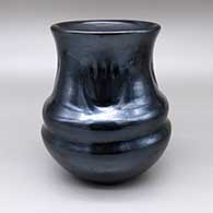 Polished black double-shouldered jar with a slightly flared opening and a four-panel indented bear paw design
 by LuAnn Tafoya of Santa Clara