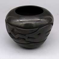 Black jar with carved avanyu design
 by Unknown of Cochiti