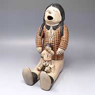 Polychrome storyteller with one child and dog
 by Helen Cordero of Cochiti
