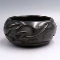 Black bowl with a stylized avanyu design carved around the body
 by Belen Tapia of Santa Clara