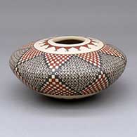 A polychrome seed pot decorated with a quadrillos and geometric design
 by Carmen Veloz of Mata Ortiz and Casas Grandes