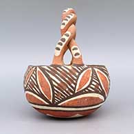 Polychrome friendship basket with twisted handle and geometric design, click or tap to see a larger version