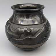 Black jar with flared rim and carved stylized avanyu design
 by Nathan Youngblood of Santa Clara