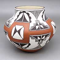Polychrome jar with a four-panel fine line, kiva step, and geometric design; includes photographs of the artist holding the piece
 by Lee Ann Cheromiah of Laguna