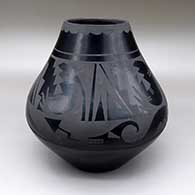 A black-on-black jar with an avanyu and geometric design
 by Carmelita Dunlap of San Ildefonso