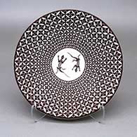 Small black-on-white plate with a lizard and geometric design
 by Rebecca Lucario of Acoma