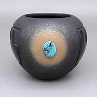 Micaceous black jar with a sienna spot, a lightly carved and polished feather ring geometric design, and an inlaid turquoise stone detail
 by Dora Tse Pe of San Ildefonso