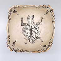 Black-on-white prayer bowl with a tadpole, frog, tadpole, and kiva step geometric design
 by Unknown of Zuni