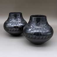 Set of two black-on-black jars, each with a painted feather ring and geometric design
 by Maria Martinez of San Ildefonso