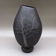 Black jar and gray jar with an asymmetrical cut opening, a painted tree design, and a matching stand
 by Pabla Quezada of Mata Ortiz and Casas Grandes