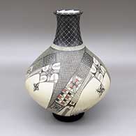 Polychrome jar with a tall neck, a flared opening, and a geometric design
 by Jose Quezada of Mata Ortiz and Casas Grandes