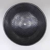 Large black bowl with an indented geometric design
 by Reynaldo Quezada of Mata Ortiz and Casas Grandes