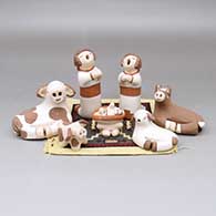 Seven-piece polychrome nativity set with a woven rug
 by Mona Teller of Isleta