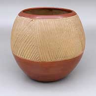 Red bowl with a lightly carved geometric design around exterior
 by Rosita Cata of Ohkay Owingeh